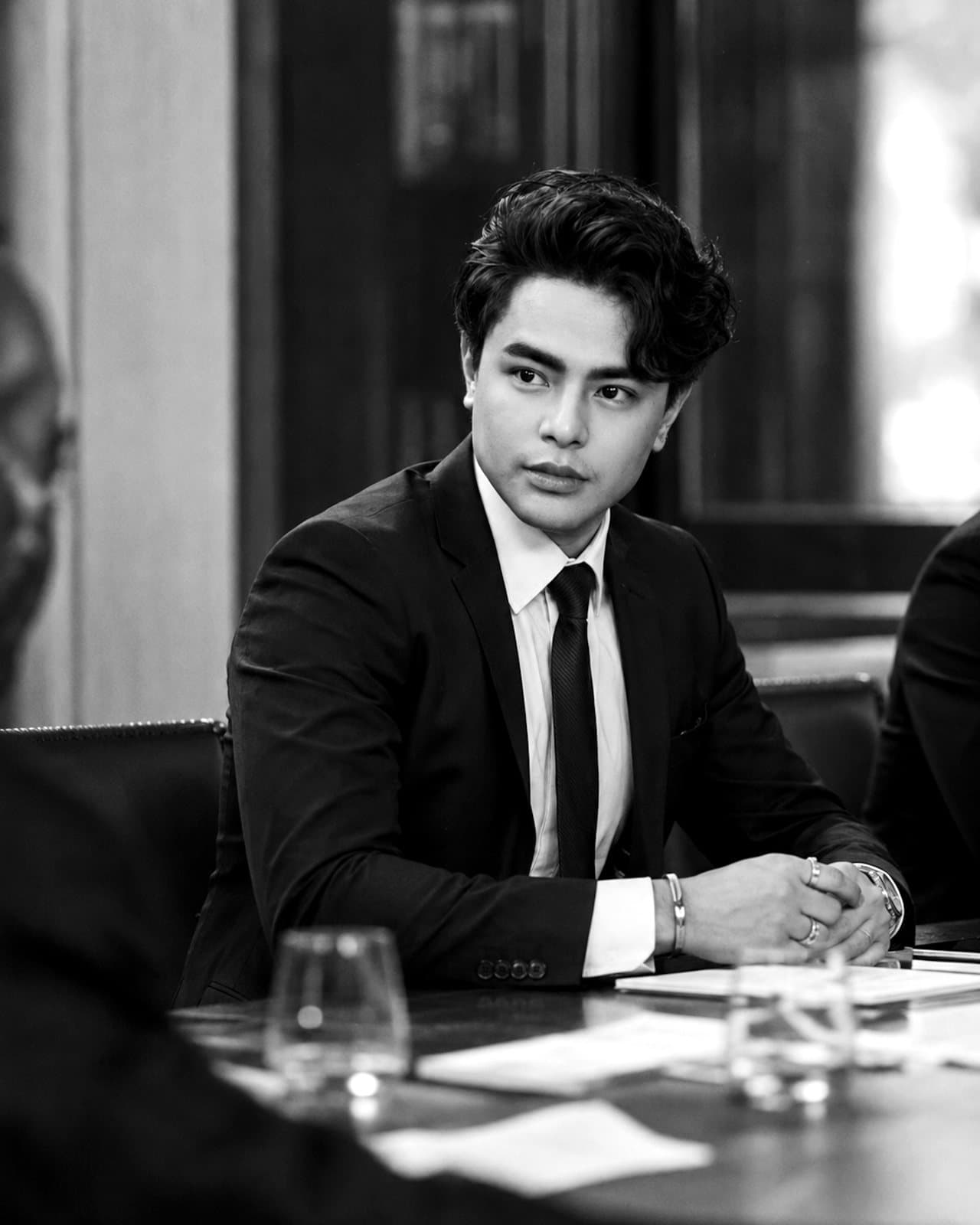 Prof. Voxstra Corbett seated at a boardroom table during an institutional meeting
